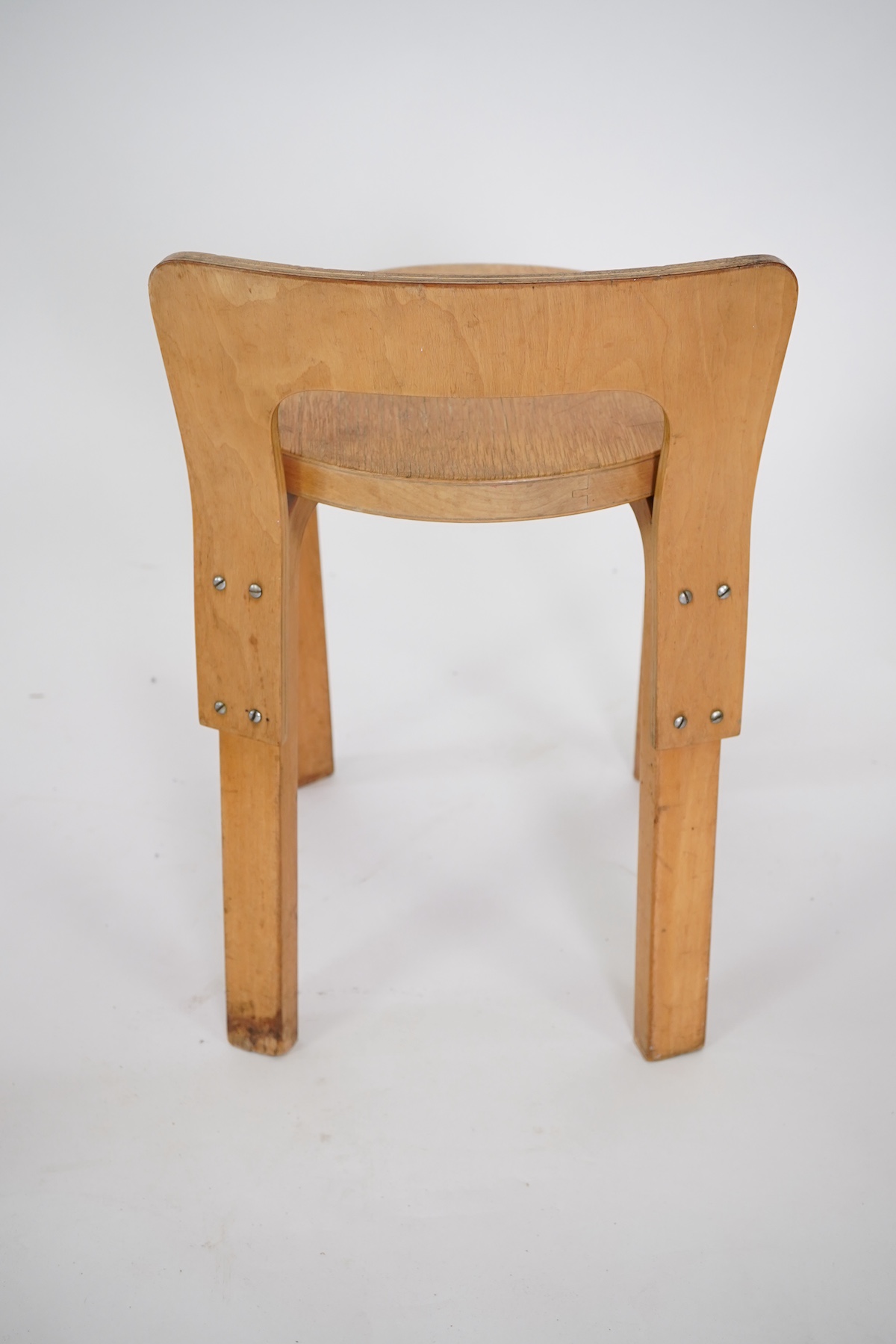 Alvar Aalto (Finnish 1898-1976) for Artek, distributed by Finmar: A pair of 'Model 60' stools and a similar 'K65' stool